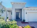 Inviting front entrance with brick walkway and covered porch, perfect curb appeal at 1009 Hendon Loop, Davenport, FL 33837