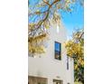 Architectural detail of a modern white home, emphasizing clean lines and bright, natural lighting at 1018 Stetson St, Orlando, FL 32804