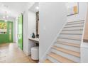 Hallway view featuring a vanity area, staircase, and green door that adds a touch of color at 1018 Stetson St, Orlando, FL 32804