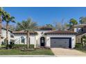 Beautiful single-Gathering home shows neutral paint, a gray garage door and a well-kept lawn at 1377 Tappie Toorie Cir, Lake Mary, FL 32746