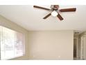 Bright living room featuring a ceiling fan and large window for natural light at 1389 Rural Hall St, Deltona, FL 32725