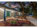 Inviting home exterior with a brick facade, covered porch, manicured landscaping, and driveway with landscape lighting at 140 Sweet Bay Cir, Lake Mary, FL 32746