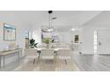 Elegant dining area with stylish furniture, modern lighting, and an open floor plan, ideal for entertaining guests at 150 Chicago Woods Cir, Orlando, FL 32824