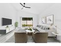 Bright living room with modern furniture, a large window, and a ceiling fan, creating a relaxing atmosphere at 150 Chicago Woods Cir, Orlando, FL 32824