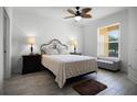 Comfortable bedroom with neutral tones, wood-look tile flooring and natural light at 19914 Villa Creek Dr # 105, Orlando, FL 32821