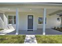 Inviting front porch with classic columns and neutral color palette at 216 Homewood Dr, Sanford, FL 32773