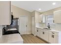 Modern kitchen featuring white cabinets, stainless steel appliances, and a stylish backsplash at 237 Clarinet Way, Davenport, FL 33896