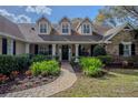 Charming home featuring a brick pathway, well-manicured landscaping, and a welcoming front entrance at 31707 Orange St, Sorrento, FL 32776