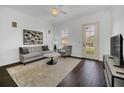 Bright living room featuring a ceiling fan, a neutral color palette, and dark hardwood floors at 506 Mirasol Cir # 202, Celebration, FL 34747