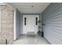 Covered entrance with neutral siding and white door with sidelights at 5336 White Cliff Ln # 6, Orlando, FL 32812