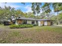 Charming single story home with white siding, stone accents, well-kept landscaping and a welcoming, classic design at 5374 Crooked Oak Cir, St Cloud, FL 34771