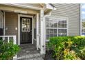 Inviting entrance with decorative door and attractive landscaping at 6050 Scotchwood Gln # Ge, Orlando, FL 32822