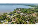 An aerial view of a lakefront community, showcasing homes nestled among lush trees and serene water views at 6424 Jenny Dr, Lake Wales, FL 33898