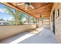 Screened patio with wood ceiling and two fans features brick siding, and open view of yard at 6424 Jenny Dr, Lake Wales, FL 33898