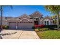 Attractive home with a three-car garage, neat landscaping, and a manicured lawn at 6854 Remington View Ct, Orlando, FL 32829