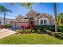 Inviting home with a well-maintained lawn, vibrant plants, and a spacious three-car garage at 6854 Remington View Ct, Orlando, FL 32829