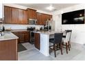 Bright kitchen with stainless steel appliances, granite counters and seating at the kitchen island at 7407 Ripplepointe Way, Windermere, FL 34786