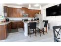 Bright kitchen with stainless steel appliances, granite counters and seating at the kitchen island at 7407 Ripplepointe Way, Windermere, FL 34786