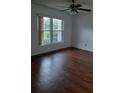 Cozy bedroom showcasing hardwood floors, natural light, and ceiling fan at 824 Town Cir # 101, Maitland, FL 32751