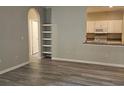 Spacious living room with neutral tones, built in shelving, and access to the kitchen at 860 Orange Ave # 259, Orlando, FL 32801