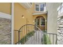 Gated entrance to home with a stone-paved path leading to a covered entryway at 9236 Sweet Maple Ave, Orlando, FL 32832