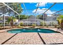 Inviting screened-in pool area with a spa, brick pavers, and lush landscaping, creating a serene outdoor oasis at 929 Arbormoor Pl, Lake Mary, FL 32746