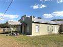 Attractive one-story home with a metal roof, featuring a covered entrance and well-kept grounds at 100 John St, Frostproof, FL 33843