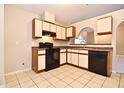 Cozy kitchen with dark appliances, light countertops, and classic cabinetry at 107 Broadarrow Pl, Sanford, FL 32773