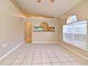 Bright living room featuring tile floors, and arched windows, creating an open and airy space at 107 Broadarrow Pl, Sanford, FL 32773