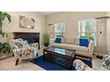 Inviting living room with fireplace, large windows, and comfortable seating arrangements at 10942 High Bush Ct, Orlando, FL 32825