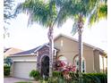 Charming single-story home featuring lush landscaping, a stone-accented entryway, and a two-car garage at 10942 High Bush Ct, Orlando, FL 32825