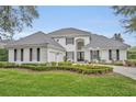 Stunning two-story home boasts manicured landscaping, a driveway, and a tile roof at 142 Stone Hill Dr, Maitland, FL 32751