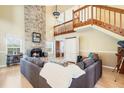Bright living room featuring wood floors, a brick fireplace, and a wood staircase at 1751 Meadowgold Ln, Winter Park, FL 32792