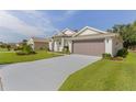 Single Gathering home with a two car garage and long driveway at 24515 Bocage Way, Leesburg, FL 34748
