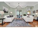 Bright living room with neutral colors, modern lighting, and backyard view at 24515 Bocage Way, Leesburg, FL 34748