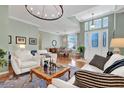 Open concept living room with hardwood floors and abundant natural light at 24515 Bocage Way, Leesburg, FL 34748