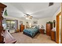 Cozy bedroom with a ceiling fan, dresser, and a window offering plenty of natural light at 2696 Orange Peel Ct, Orlando, FL 32806