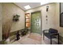 Enclosed front entry with a textured wall finish with bench and decorations at 2696 Orange Peel Ct, Orlando, FL 32806