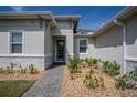 Close up of the front entry with a brick paver walkway and landscaping at 2720 Bancroft Blvd, Orlando, FL 32833