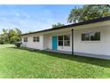 Charming home featuring a well-maintained lawn and a bright, welcoming blue front door at 305 Hope Cir, Orlando, FL 32811