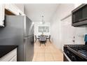 Cozy kitchen with stainless steel refrigerator and eating area, perfect for casual dining at 305 Hope Cir, Orlando, FL 32811