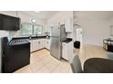 A well-equipped kitchen with stainless steel appliances and black countertops for stylish cooking at 305 Hope Cir, Orlando, FL 32811