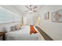 Comfortable main bedroom with a ceiling fan, soft textures, a modern art piece, and a relaxing ambiance at 305 Hope Cir, Orlando, FL 32811