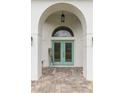 Inviting entryway featuring double doors and a charming welcome sign at 30912 Fairvista Dr, Tavares, FL 32778