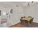 A well-lit dining room featuring a table with seating for six and a pass through to the kitchen at 325 N Causeway # 2080, New Smyrna Beach, FL 32169