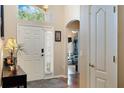 Bright and inviting foyer with a decorative front door, high ceilings, and a view into the living area at 3655 Seminole Dr, Orlando, FL 32812