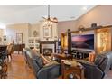 Cozy living room with a fireplace, entertainment center, comfortable seating, and ample natural light at 3655 Seminole Dr, Orlando, FL 32812