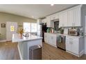 Bright kitchen featuring white cabinets, stainless steel appliances, and a kitchen island with a white countertop at 427 Zimmerman Dr, Orlando, FL 32839