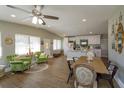 Inviting living space with wood floors, bright windows, comfortable seating, and a kitchen in the background at 427 Zimmerman Dr, Orlando, FL 32839