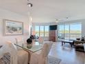 A dining room and sitting area featuring floor to ceiling windows at 434 Bouchelle Dr # 202, New Smyrna Beach, FL 32169